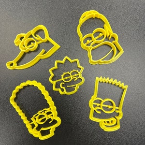 May include: Set of five yellow plastic cookie cutters shaped like the Simpsons characters: Homer, Marge, Bart, Lisa, and Santa's Little Helper.
