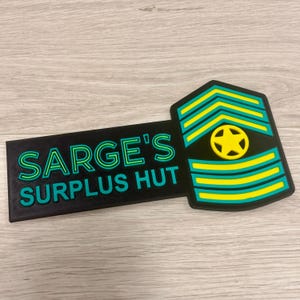 May include: A black and green sign with the text "SARGE'S SURPLUS HUT" in a neon style font. The sign also features a military rank insignia with yellow and green stripes and a yellow star.