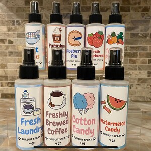May include: A collection of nine clear plastic spray bottles, each containing 4 oz of fursuit spray. The labels feature colorful illustrations of scents like fruit loops, pumpkin, blueberry pie, strawberries, tropical fruit, laundry, coffee, cotton candy, and watermelon.