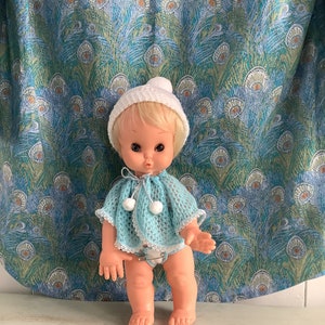A vintage baby doll made in England in the 1960s with two outfits.