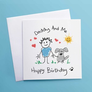 May include: A white card with a hand-drawn illustration of a person and a dog. The text "Daddy And Me" is written at the top of the card. The text "Happy Birthday" is written at the bottom of the card.