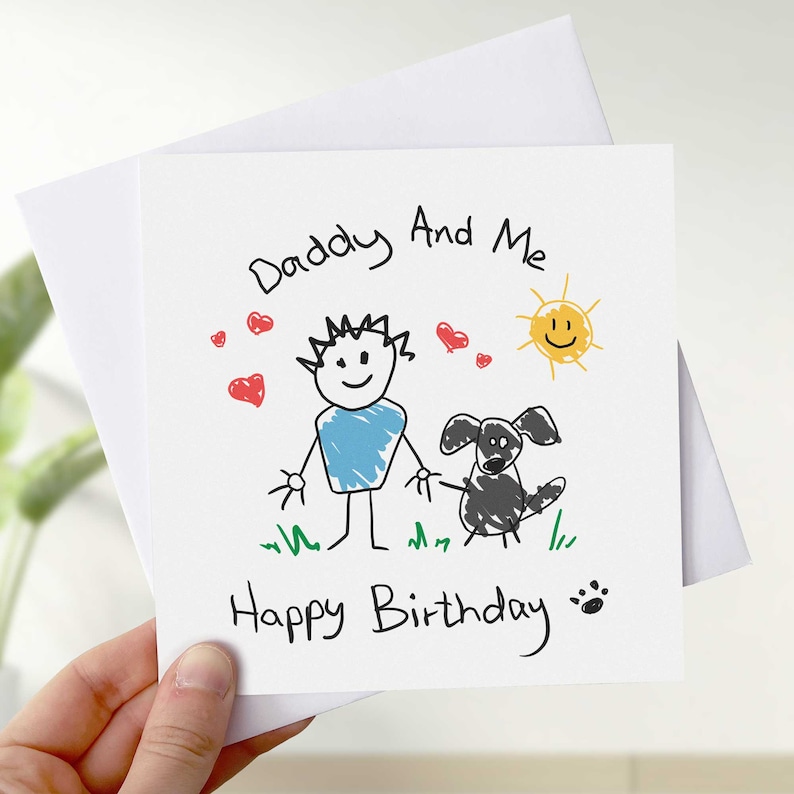 May include: A white card with a hand-drawn illustration of a person, a dog, and a sun. The text reads "Daddy And Me" and "Happy Birthday".