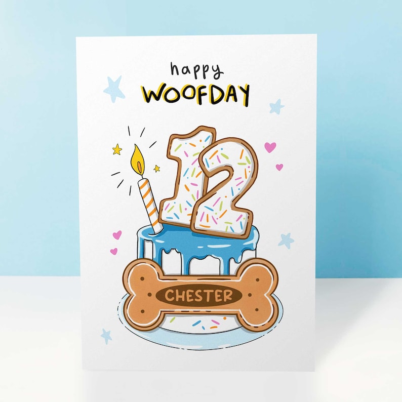 May include: A birthday card with the words "happy WOOFDAY" in black and yellow. The card features a blue cake with the number 12 on top, decorated with sprinkles. A bone-shaped cookie with the name "CHESTER" is at the bottom.