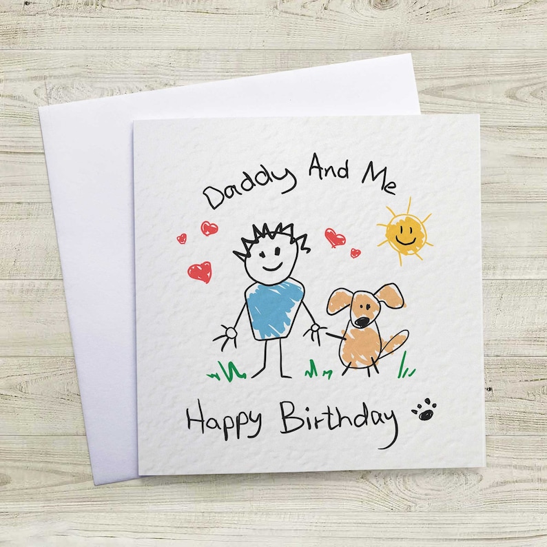 May include: A white card with a hand-drawn illustration of a person and a dog. The text reads "Daddy And Me Happy Birthday" with hearts and a sun drawn around the figures.