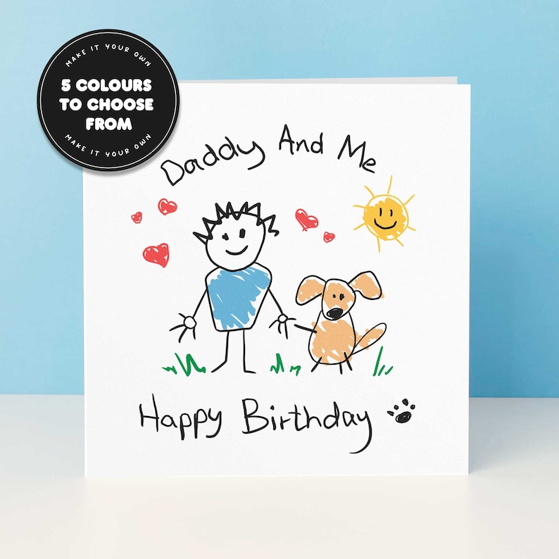 May include: A white card with a hand-drawn illustration of a person, a dog, and a sun. The text "Daddy And Me" and "Happy Birthday" is written in black marker.