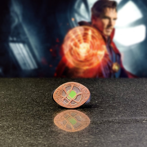 Dr Strange inspired Eye of Agamotto bronze coated enamel pin with glow in the dark centre eye