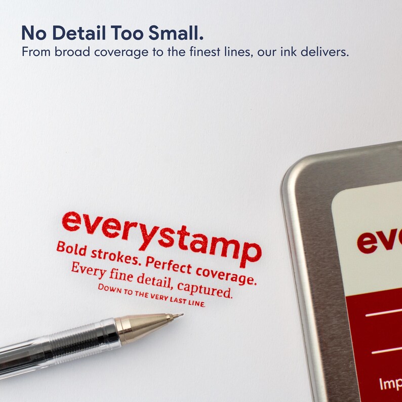 May include: A close-up of a silver pen with a gold tip, positioned near the red text "everystamp" on a white surface. The text emphasizes bold strokes and perfect coverage. Additional text reads "No Detail Too Small."