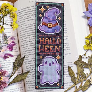 May include: A black and purple Halloween bookmark with a witch's hat, a ghost, and the text "Hallo Ween".