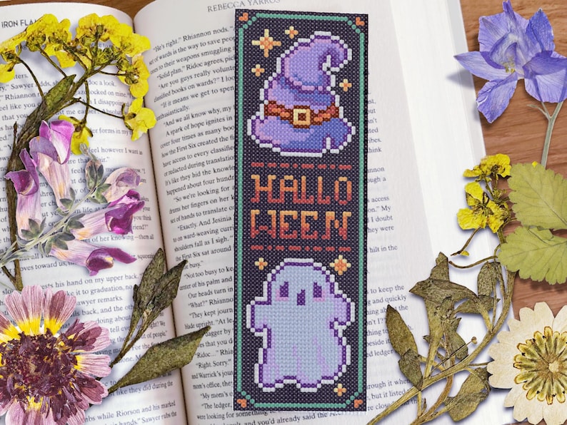 May include: A black and purple Halloween bookmark with a witch's hat, a ghost, and the text "Hallo Ween".