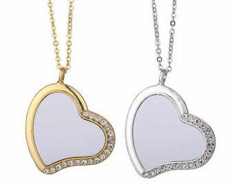 May include: Two heart-shaped necklaces with clear crystal accents. One necklace is gold and the other is silver.