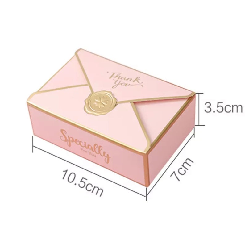 May include: Pink envelope-shaped gift box with gold accents. The box is 10.5 inches long, 7 inches wide, and 3.5 inches tall. The box has the text "Thank You" and "Specially for you" printed on it.