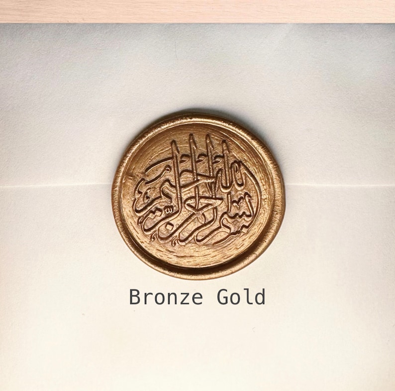 May include: A bronze gold wax seal with an Arabic calligraphy design.