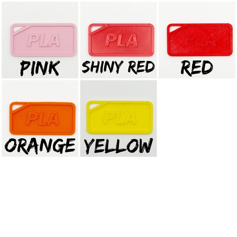 May include: A selection of rectangular PLA tags in shades of pink, shiny red, red, orange, and yellow. Each tag features a small corner hole and the embossed letters "PLA". The colours are labelled with bold, black text.