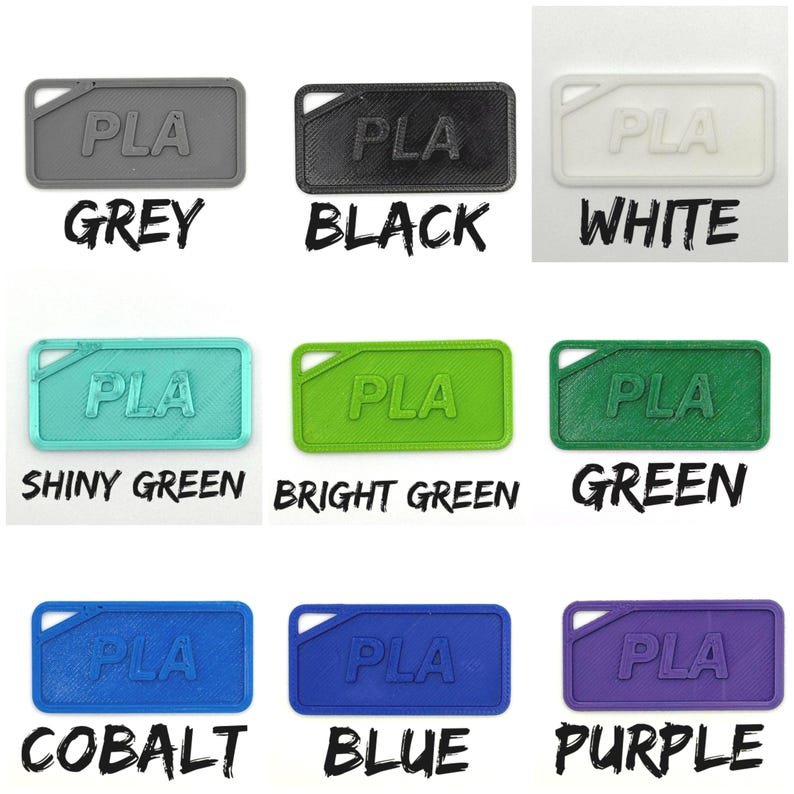 May include: Nine rectangular PLA plastic tags in a range of colours: grey, black, white, shiny green, bright green, green, cobalt, blue, and purple. Each tag features the letters "PLA" and a small hole in the upper left corner. The colour names are written below each tag.