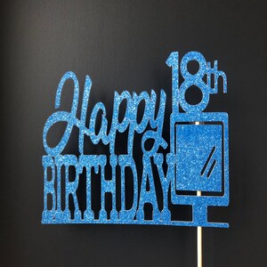May include: Blue glitter cake topper with the text "Happy 18th Birthday".