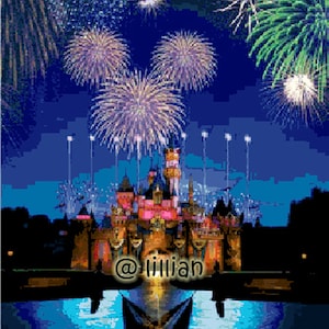 May include: A nighttime view of a castle-like building with fireworks exploding in the sky above. The castle is lit up with colorful lights and there is a reflection of the fireworks in the water in front of it. The text "@iillian" is visible in the foreground.