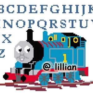 May include: A blue and black toy train engine with a smiling face, red wheels, and the number "1" on the side. The engine is on a brown track. The text "@lillian" is below the engine.