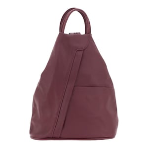 May include: A deep burgundy backpack with a triangular silhouette, featuring a single top handle, a smooth matte finish, and a vertical stitched seam detail running down the front panel. The bag has a clean, structured design with a flat base.
