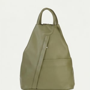 May include: An olive green backpack with a smooth finish, featuring a top handle, a vertical front strap detail, and a horizontal pocket. The text FALL COLLECTION is printed in black in the upper left corner of the image.