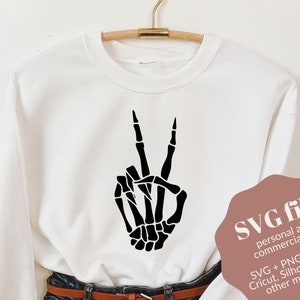 Signo de paz de la mano del esqueleto, SVG de la mano del esqueleto, anillo de mano del esqueleto, esqueleto svg, sudadera con capucha del esqueleto, esqueleto de baile svg, pendiente de halloween svg