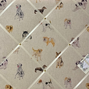 May include: A beige fabric notice board with a grid pattern of white ribbon. The board is decorated with a repeating pattern of watercolor illustrations of various dog breeds.