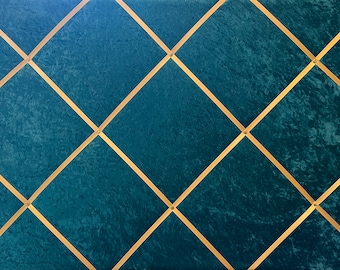May include: A teal blue wall with a diamond pattern created by gold strips. The strips are attached to the wall with small gold tacks.
