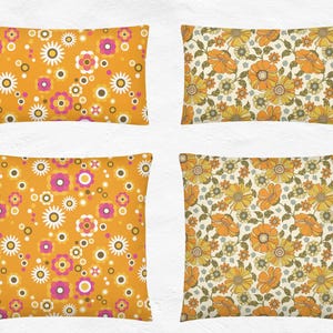 May include: Four decorative throw pillows with floral patterns. Two pillows feature a mustard yellow background with white, pink, and brown flowers. The other two pillows have a cream background with orange and yellow flowers.