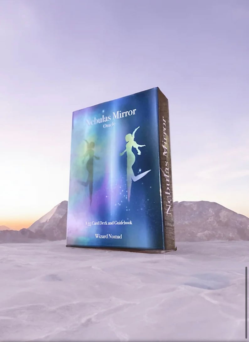 K&ouml;nnte beinhalten: Eine blaue und violette Orakelkarten-Deckbox mit dem Titel "Nebulas Mirror Oracle" und dem Text "A 45 Card Deck and Guidebook, Wizard Nomad".