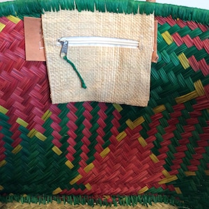 May include: A woven basket with a red, green, and yellow pattern. The basket has a zippered pocket on the front.