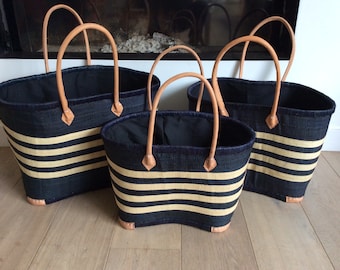 Large double raffia basket with long handles and closing pouch.