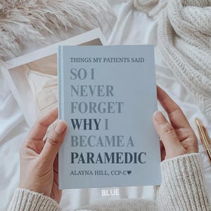 May include: A light blue book titled "THINGS MY PATIENTS SAID" with the text "SO I NEVER FORGET WHY I BECAME A PARAMEDIC." The author's name, "ALAYNA HILL, CCP-C❤," is also printed on the cover. The word "BLUE" is at the bottom.