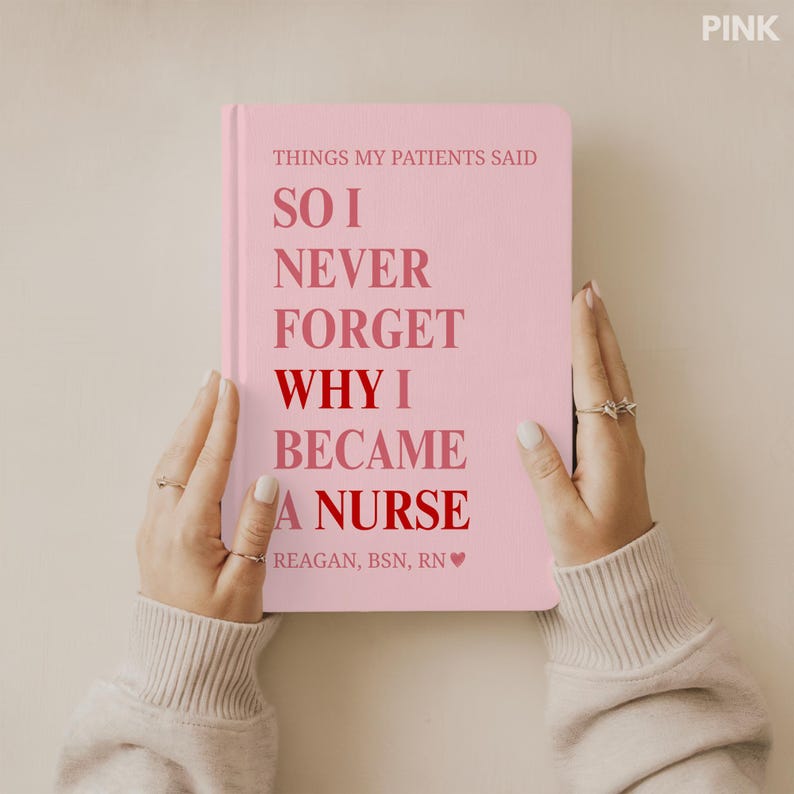 May include: A pink notebook with the text "THINGS MY PATIENTS SAID" and "SO I NEVER FORGET WHY I BECAME A NURSE." The notebook is held by hands and has the name "REAGAN, BSN, RN" at the bottom. The word "PINK" is in the top right corner.