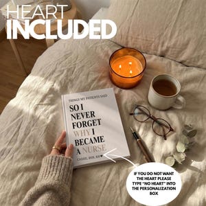 May include: A book titled "SO I NEVER FORGET WHY I BECAME A NURSE" with text "HEART INCLUDED". The image also shows a lit candle in a glass jar, a cup of tea, eyeglasses, and a pen. The text on the image says "IF YOU DO NOT WANT THE HEART PLEASE TYPE "NO HEART" INTO THE PERSONALIZATION BOX."