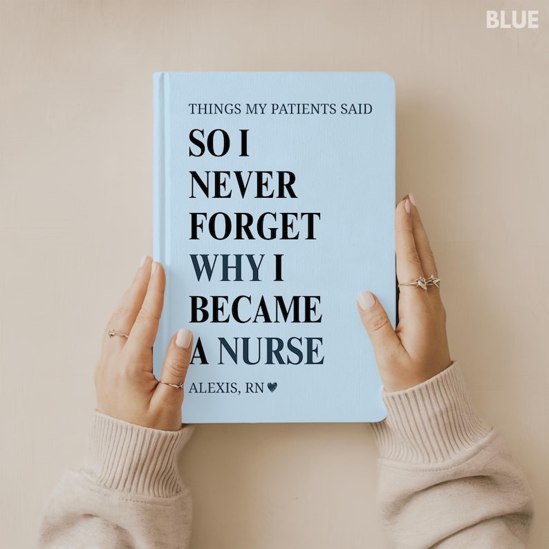 May include: A light blue notebook with the text "THINGS MY PATIENTS SAID SO I NEVER FORGET WHY I BECAME A NURSE ALEXIS, RN". The notebook is held by two hands with rings.