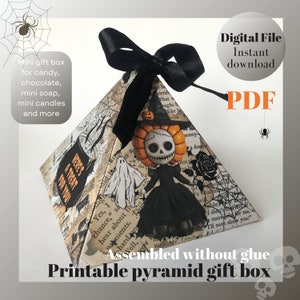 May include: Printable Halloween-themed pyramid gift box with a black ribbon and a spooky character design. The box is assembled without glue and is perfect for holding small gifts or treats. The text on the box reads "Here's a Treat for You!"