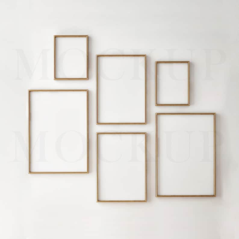 May include: Five gold picture frames of different sizes are arranged on a white wall. The frames are empty and ready for photos or artwork.