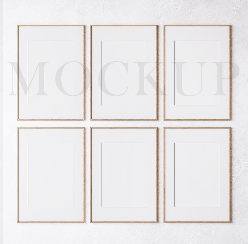 May include: Six empty picture frames with a light wood finish are arranged in two rows of three on a white textured wall. The frames are all the same size and have a simple, modern design.