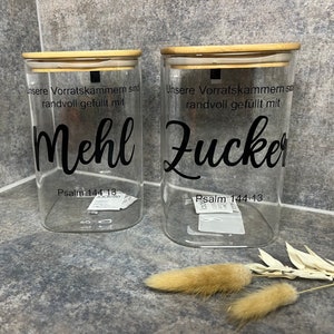 Storage jars of flour and sugar with a Bible verse