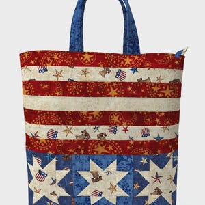 May include: Stars & Bars Tote bag with blue handles. The tote features a patriotic design with red and white stripes, stars, and patriotic symbols. Finished size is 17" wide x 13.25" high x 3.5" deep.