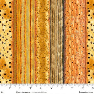 May include: Fabric with a repeating pattern of vertical stripes in shades of gold, orange, and brown. The stripes vary in texture, including dotted and lined designs. The image includes a ruler along the bottom edge, with measurements in inches.