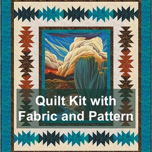 May include: A quilt kit with fabric and pattern. The quilt features a central image of a desert landscape with a cactus and clouds. The border has a turquoise, brown, and white geometric design.
