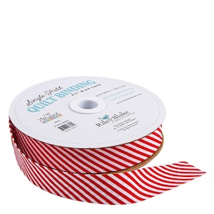 May include: A spool of red and white striped quilt binding tape. The label reads "Single-Fold Quilt Binding" and "Stripes". The tape is 1/8 inch wide and made of 100% cotton. The brand is Riley Blake Designs.