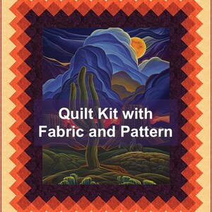 May include: A quilt kit with fabric and pattern. The quilt features a desert landscape with a cactus, mountains, and a setting sun. The border is a geometric pattern in shades of orange and brown, with a cream-colored background.