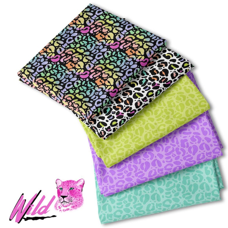 May include: A stack of five fabric squares with a leopard print pattern in various colors, including pink, green, purple, and black. The fabric squares are arranged in a pyramid shape, with the largest square at the bottom and the smallest square at the top. The fabric squares are all made of a soft, cotton material. The word "Wild" is written in pink letters on a black background in the lower left corner of the image. A cartoon leopard head is to the right of the word "Wild".