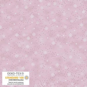 May include: Pink fabric with a pattern of white snowflakes and small dots. The fabric has a soft, textured appearance. The lower left corner features a white and yellow label with the text "OEKO-TEX STANDARD 100".