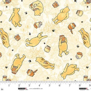 May include: Cream-colored fabric featuring a repeating pattern of a yellow bear, honey pots, and bees. The bear is depicted in various poses, some holding honey pots. The words "HUNNY" and "HON" are visible on the honey pots. The fabric has a forest-like background.