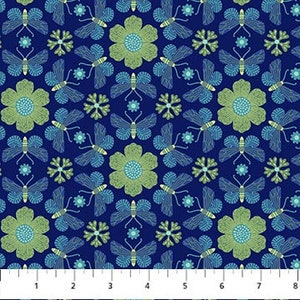 May include: A repeating pattern of butterflies, flowers, and starbursts in shades of blue, green, and yellow on a navy blue background. The pattern is printed on fabric, with a ruler along the bottom showing measurements in inches.