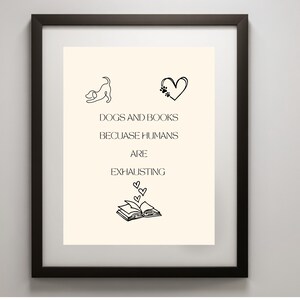 May include: A framed wall art print featuring a cream background with black line art of a dog, a heart with paw prints, and an open book with hearts. The text reads: DOGS AND BOOKS BEcUASE HUMANS ARE EXHAUSTING. The frame is dark brown.