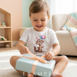 Toddler wearing white t-shirt with cute birthday animal clipart opening a gift, funny cartoon design for kids shirts, party outfits and birthday projects