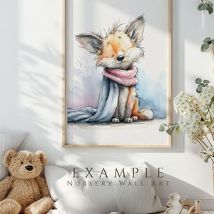 Watercolor nursery wall art mockup featuring a cute woodland fox illustration in soft pastel colors, displayed in a cozy baby room with wooden frame, teddy bear and neutral decor, example digital clipart artwork.